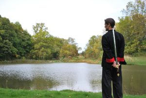 sifu holding a sword at the pond